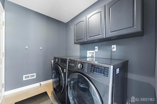 24 Saddle Ct, Monroe, NJ 08831 - laundry room with cabinet space, washer and dryer, baseboards, and wood finished floors