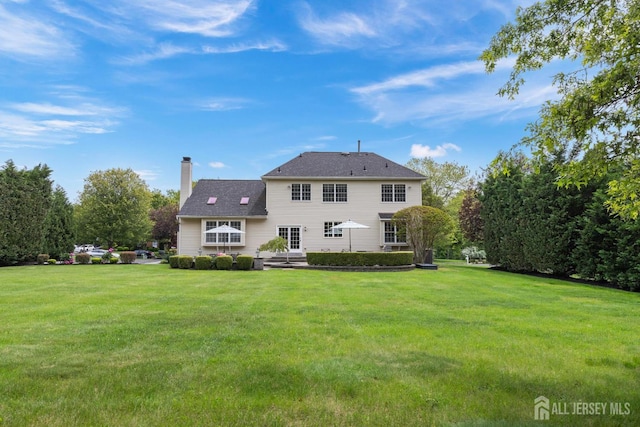 24 Saddle Ct, Monroe, NJ 08831 - back of property featuring a yard and a chimney