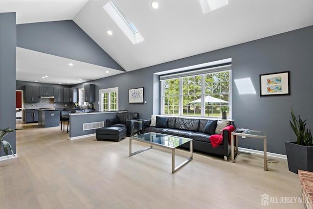24 Saddle Ct, Monroe, NJ 08831 - living area featuring a skylight, high vaulted ceiling, light wood-style floors, recessed lighting, and baseboards