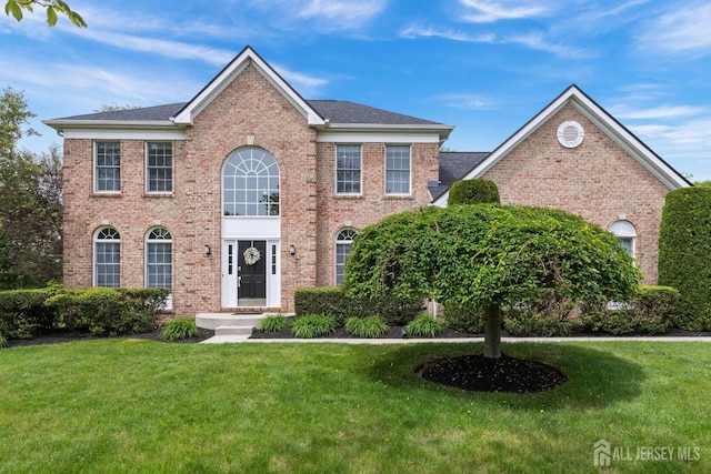 24 Saddle Ct, Monroe, NJ 08831 - view of front facade featuring a front lawn and brick siding