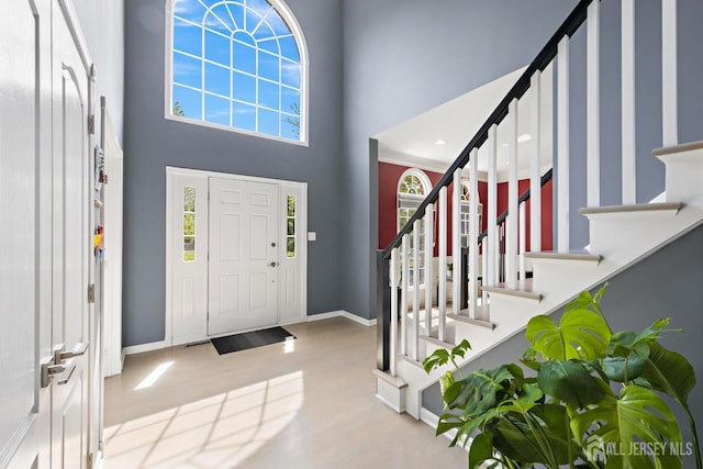 24 Saddle Ct, Monroe, NJ 08831 - foyer entrance featuring a high ceiling, baseboards, stairway, and wood finished floors
