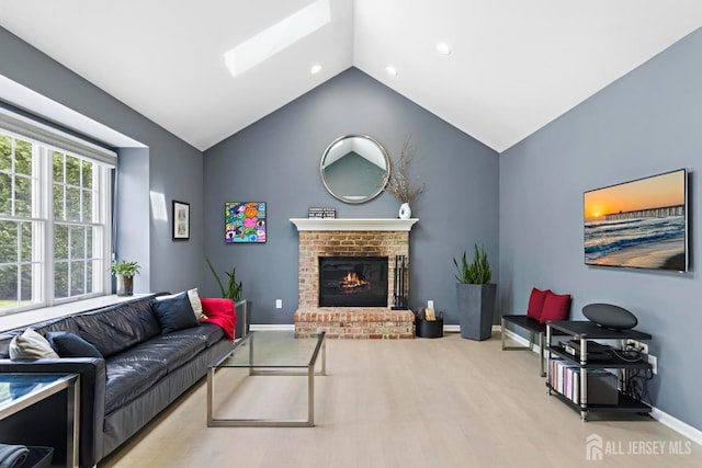 24 Saddle Ct, Monroe, NJ 08831 - living room with vaulted ceiling, baseboards, a brick fireplace, a skylight, and recessed lighting