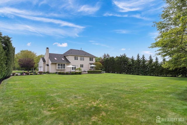 24 Saddle Ct, Monroe, NJ 08831 - back of property with a chimney and a yard