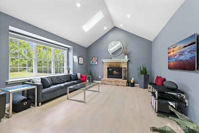 24 Saddle Ct, Monroe, NJ 08831 - living area with wood finished floors, a brick fireplace, recessed lighting, a skylight, and high vaulted ceiling