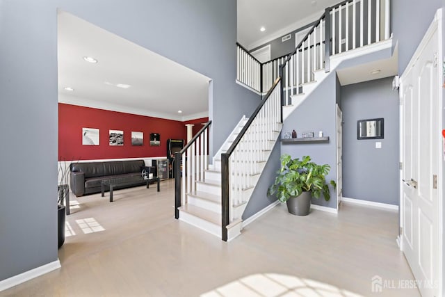 24 Saddle Ct, Monroe, NJ 08831 - staircase with a towering ceiling, ornamental molding, recessed lighting, and baseboards