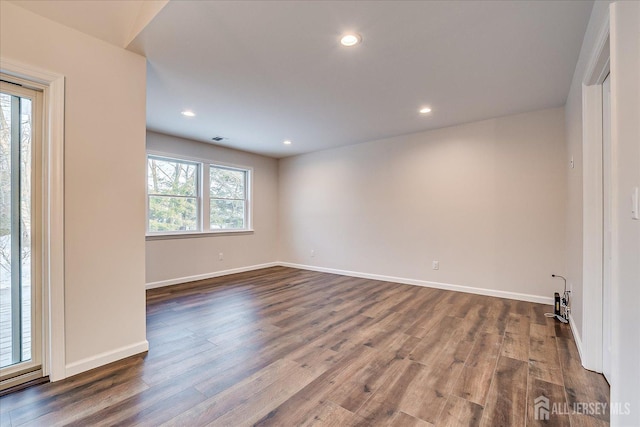 unfurnished room with hardwood / wood-style flooring