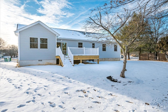 snow covered rear of property featuring a deck