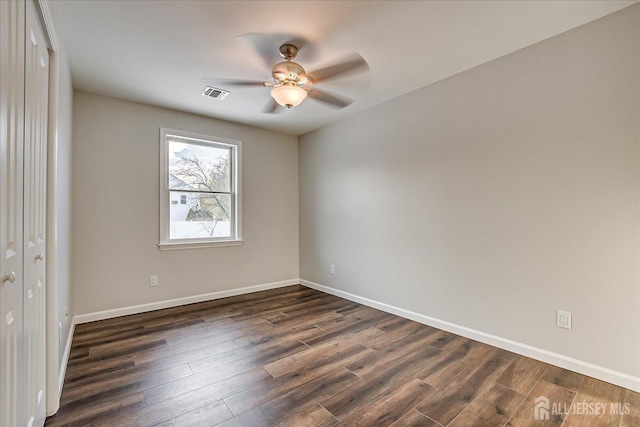 unfurnished bedroom with dark hardwood / wood-style flooring, ceiling fan, and a closet