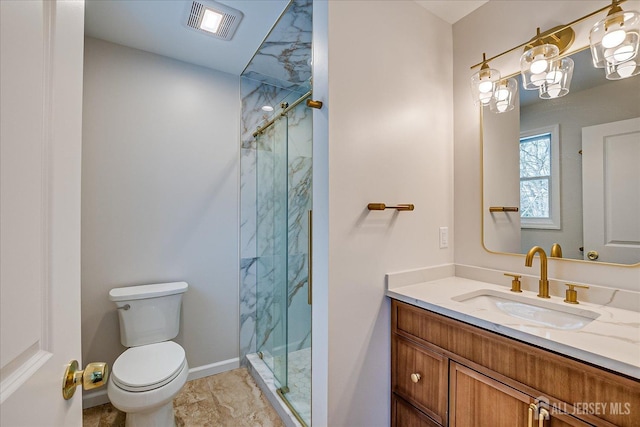 bathroom featuring vanity, a shower with door, and toilet