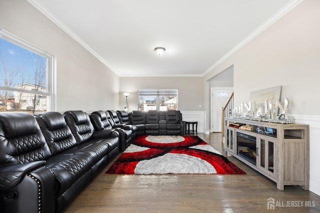 living area featuring crown molding, wood finished floors, and a wainscoted wall