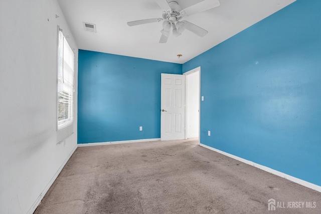 carpeted empty room with ceiling fan