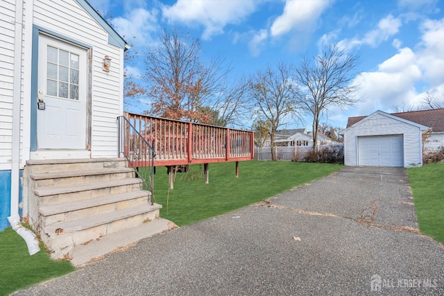 exterior space featuring a garage, an outdoor structure, and a lawn