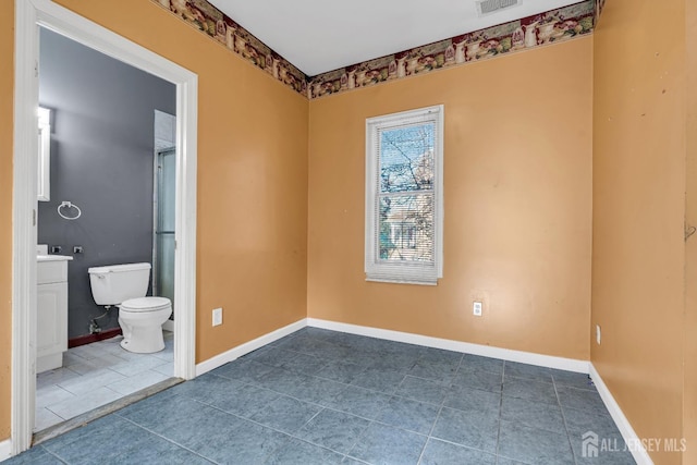 interior space featuring tile patterned flooring and toilet