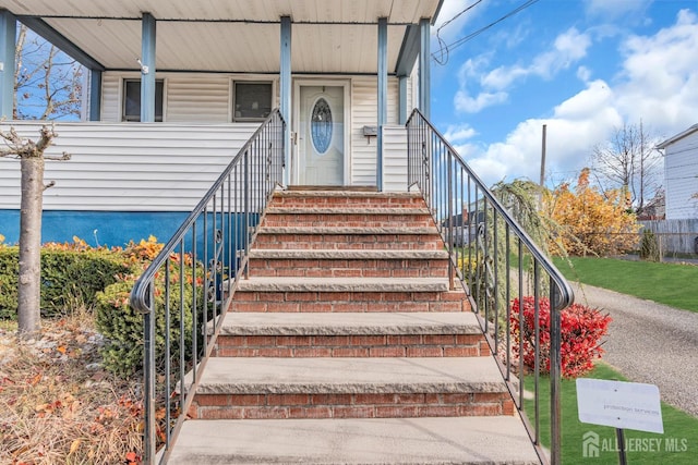 view of exterior entry with covered porch