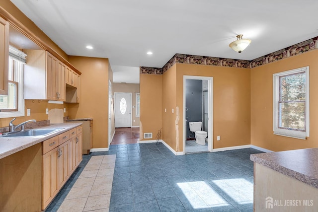 kitchen with sink, light tile patterned floors, and light brown cabinets