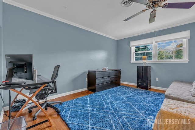 bedroom with ceiling fan, hardwood / wood-style flooring, and crown molding