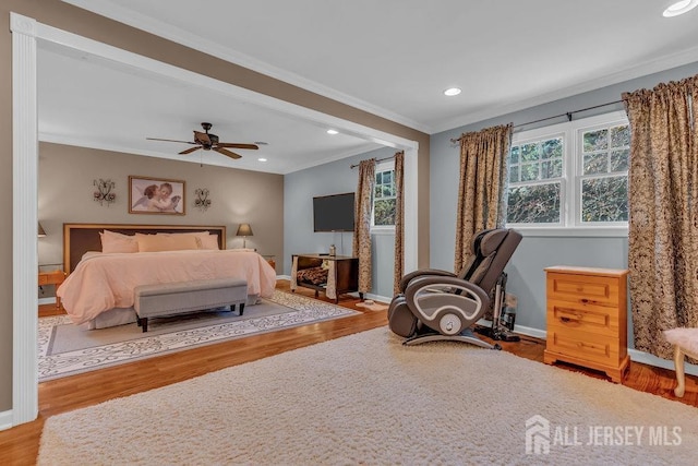 bedroom featuring ceiling fan, crown molding, and light wood-type flooring