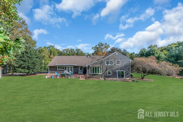 rear view of house featuring a yard and a patio area