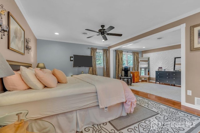 bedroom with ceiling fan, hardwood / wood-style flooring, and ornamental molding