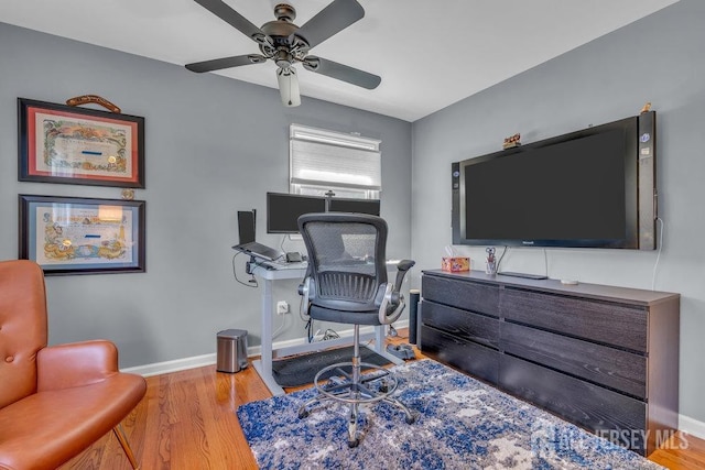 office space featuring ceiling fan and light hardwood / wood-style flooring