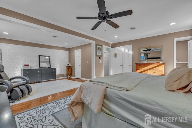 bedroom featuring ceiling fan, crown molding, and hardwood / wood-style floors