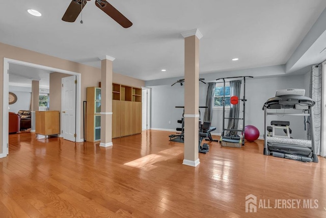 workout room with ornate columns, light hardwood / wood-style flooring, plenty of natural light, and ceiling fan