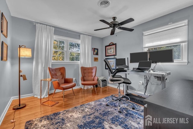 home office with hardwood / wood-style floors and ceiling fan