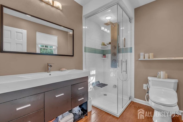 bathroom with vanity, hardwood / wood-style flooring, toilet, and walk in shower