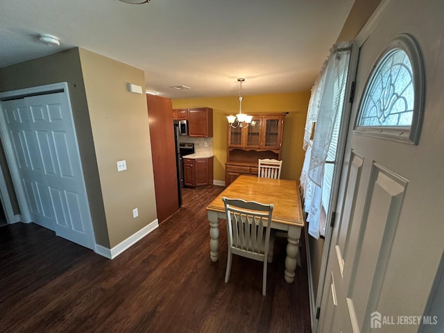 9 Maine Ct, Old Bridge, NJ 07747 - dining space featuring dark wood-style flooring and a chandelier