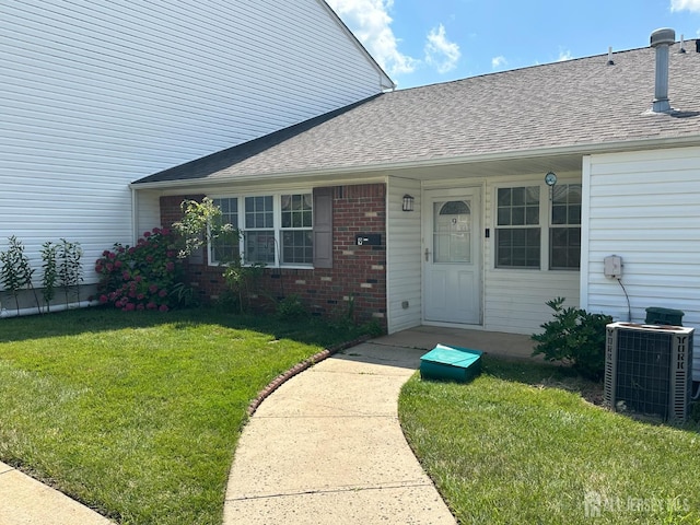 9 Maine Ct, Old Bridge, NJ 07747 - property entrance with brick siding, a lawn, and roof with shingles