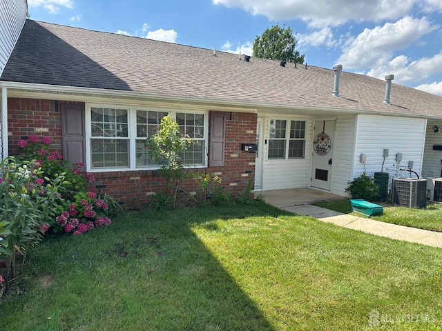9 Maine Ct, Old Bridge, NJ 07747 - back of property with brick siding, a yard, and a shingled roof