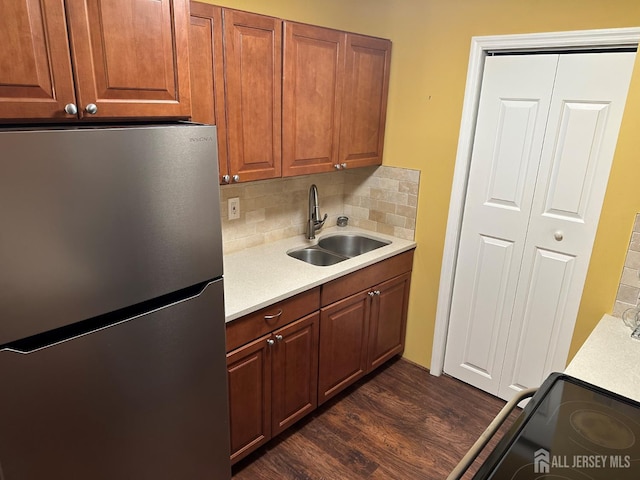 9 Maine Ct, Old Bridge, NJ 07747 - kitchen featuring freestanding refrigerator, light countertops, dark wood-style flooring, decorative backsplash, and black electric range oven