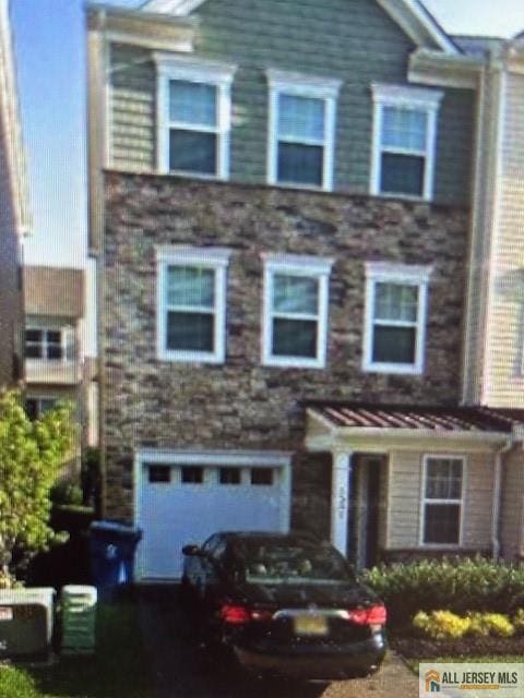 townhome / multi-family property featuring a garage