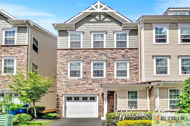 1501 Hights Farm Rd Unit 1501, Monroe, NJ 08831 - view of property featuring a garage, stone siding, and driveway