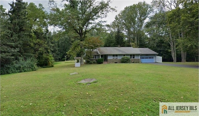 single story home featuring aphalt driveway, a front lawn, and an attached garage