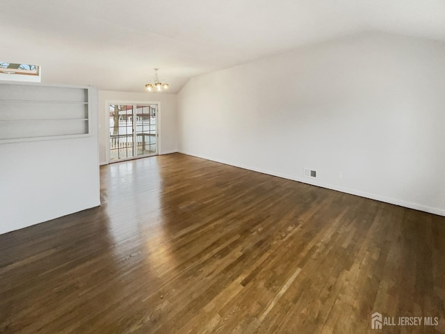 unfurnished living room with visible vents, a notable chandelier, dark wood-style floors, and vaulted ceiling