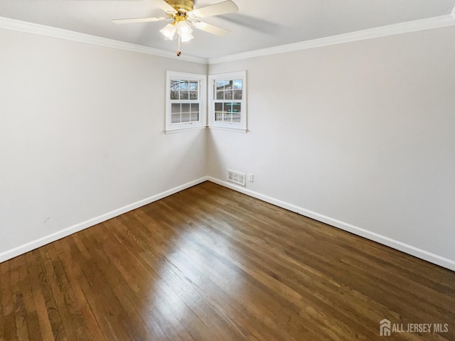 empty room featuring visible vents, baseboards, ornamental molding, wood finished floors, and a ceiling fan