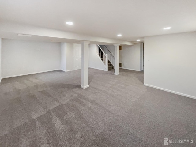 finished below grade area featuring carpet, stairway, recessed lighting, and baseboards