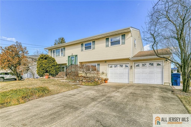 bi-level home with a garage and concrete driveway