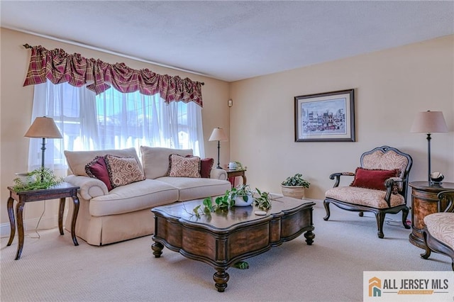 carpeted living room with baseboards