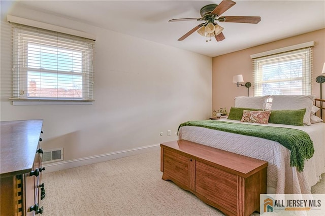 bedroom with ceiling fan, carpet, visible vents, and baseboards