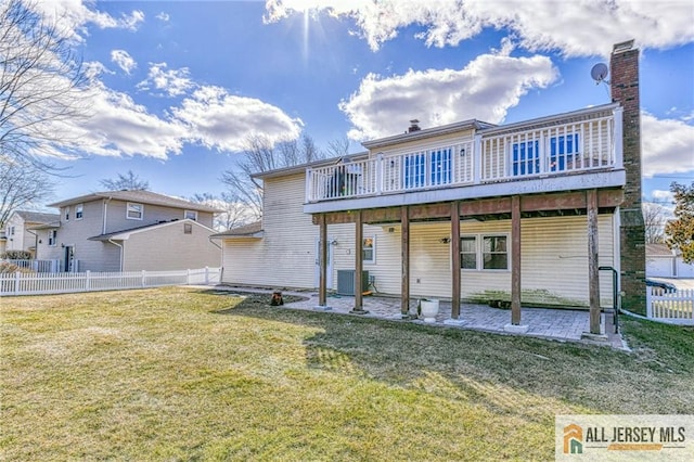 back of house with a deck, fence, a yard, a chimney, and a patio area