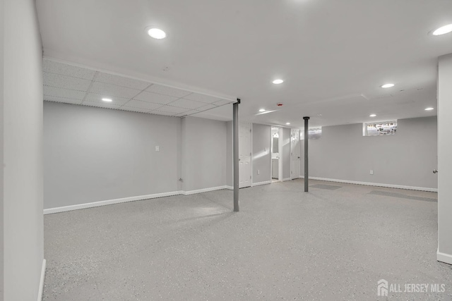 basement featuring a paneled ceiling