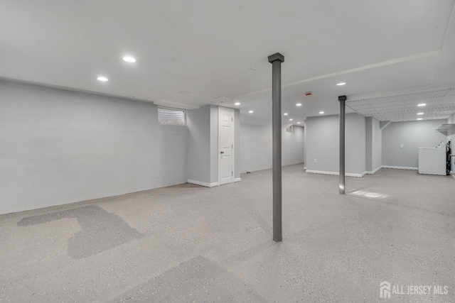 finished basement featuring washer / dryer and recessed lighting