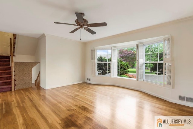 10 Lauri Ln, Middlesex, NJ 08846 - unfurnished living room with healthy amount of natural light, light wood finished floors, baseboards, and crown molding