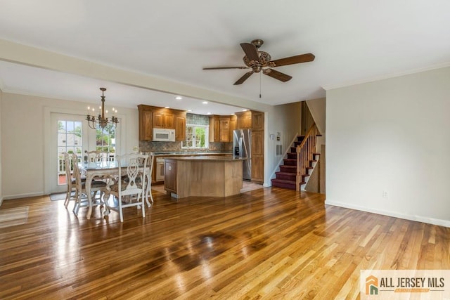 10 Lauri Ln, Middlesex, NJ 08846 - dining room with ceiling fan, wood finished floors, a chandelier, stairs, and baseboards