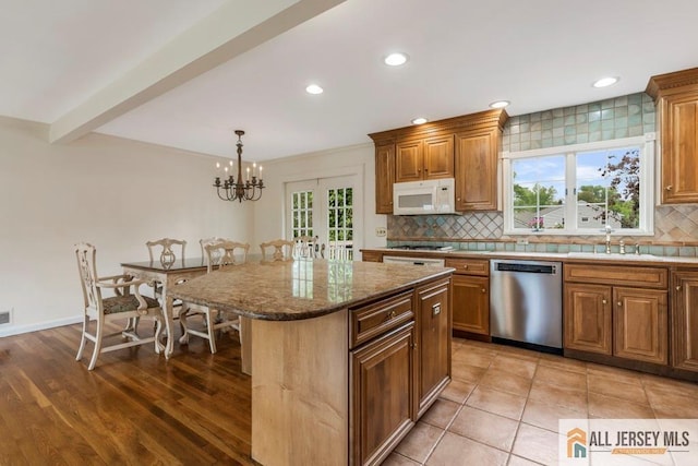 10 Lauri Ln, Middlesex, NJ 08846 - kitchen with dishwasher, white microwave, a sink, tasteful backsplash, and a kitchen island