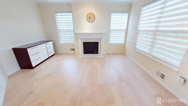 53 Kirschman Dr, Old Bridge, NJ 07747 - unfurnished living room with light wood-type flooring, plenty of natural light, a fireplace with flush hearth, and crown molding