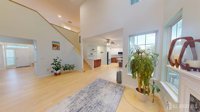 53 Kirschman Dr, Old Bridge, NJ 07747 - foyer entrance featuring stairway, a high ceiling, light wood finished floors, healthy amount of natural light, and a ceiling fan