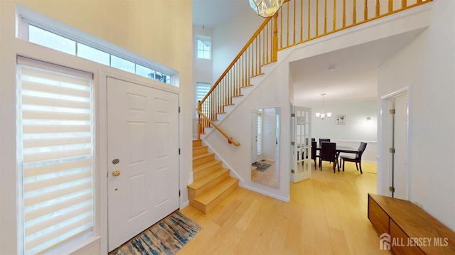 53 Kirschman Dr, Old Bridge, NJ 07747 - foyer entrance with stairway, light wood finished floors, a chandelier, and a towering ceiling